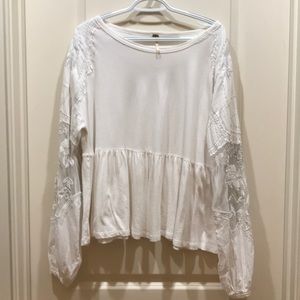 White blouse with lace sleeves.